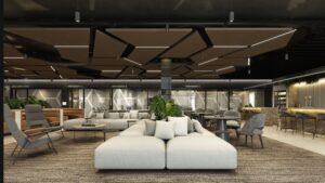 "Luxurious coworking lounge featuring modern furniture, a sleek bar area, and soundproof media rooms labeled 'Media Room A,' 'Media Room B,' and 'Media Room C,' with a golf simulator visible in the background. The space is highlighted by geometric ceiling panels, cozy seating, and abundant greenery for a contemporary, inviting atmosphere