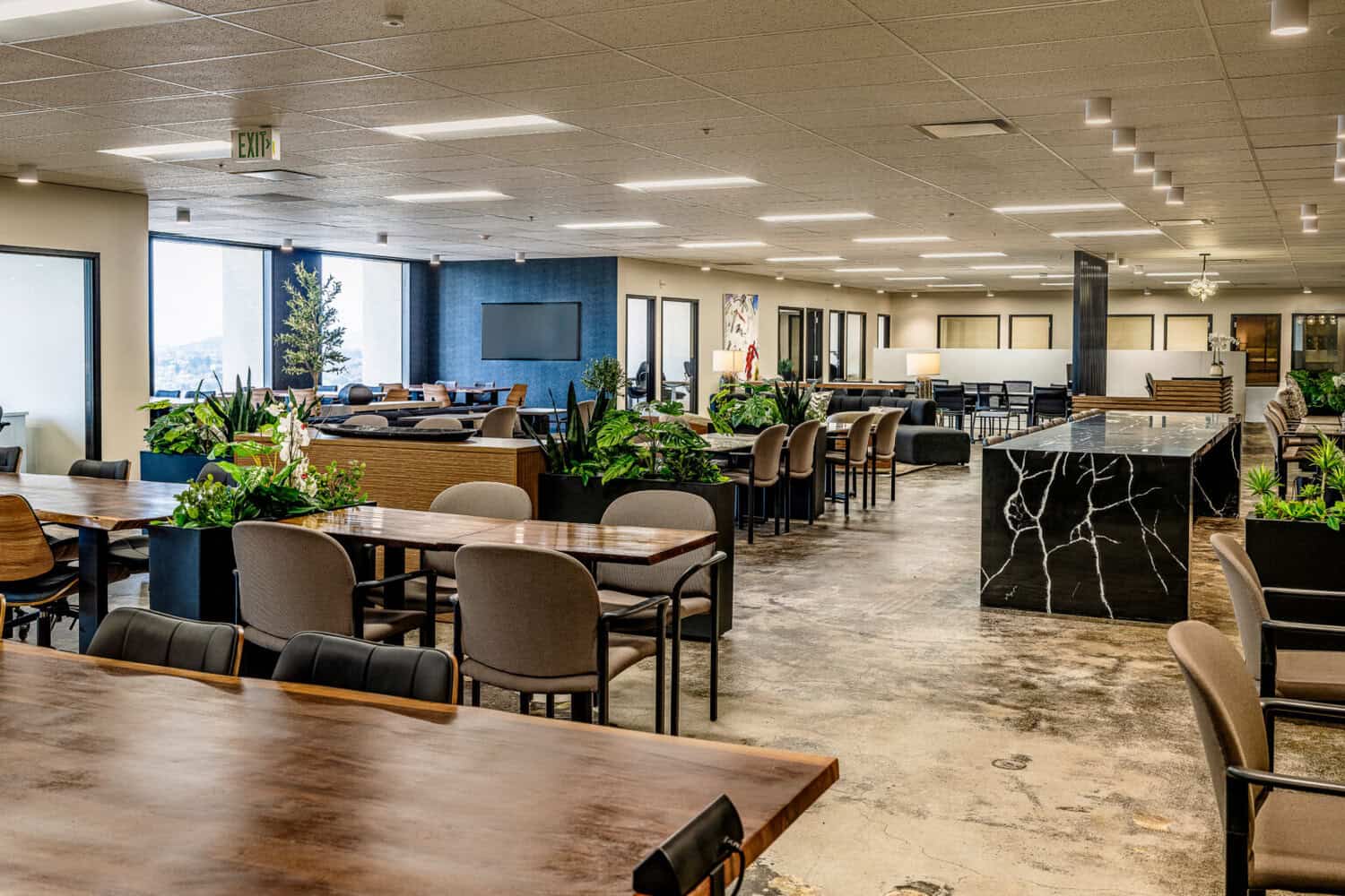 Open coworking lounge with kitchen island at STAK Space 1920 Broadway