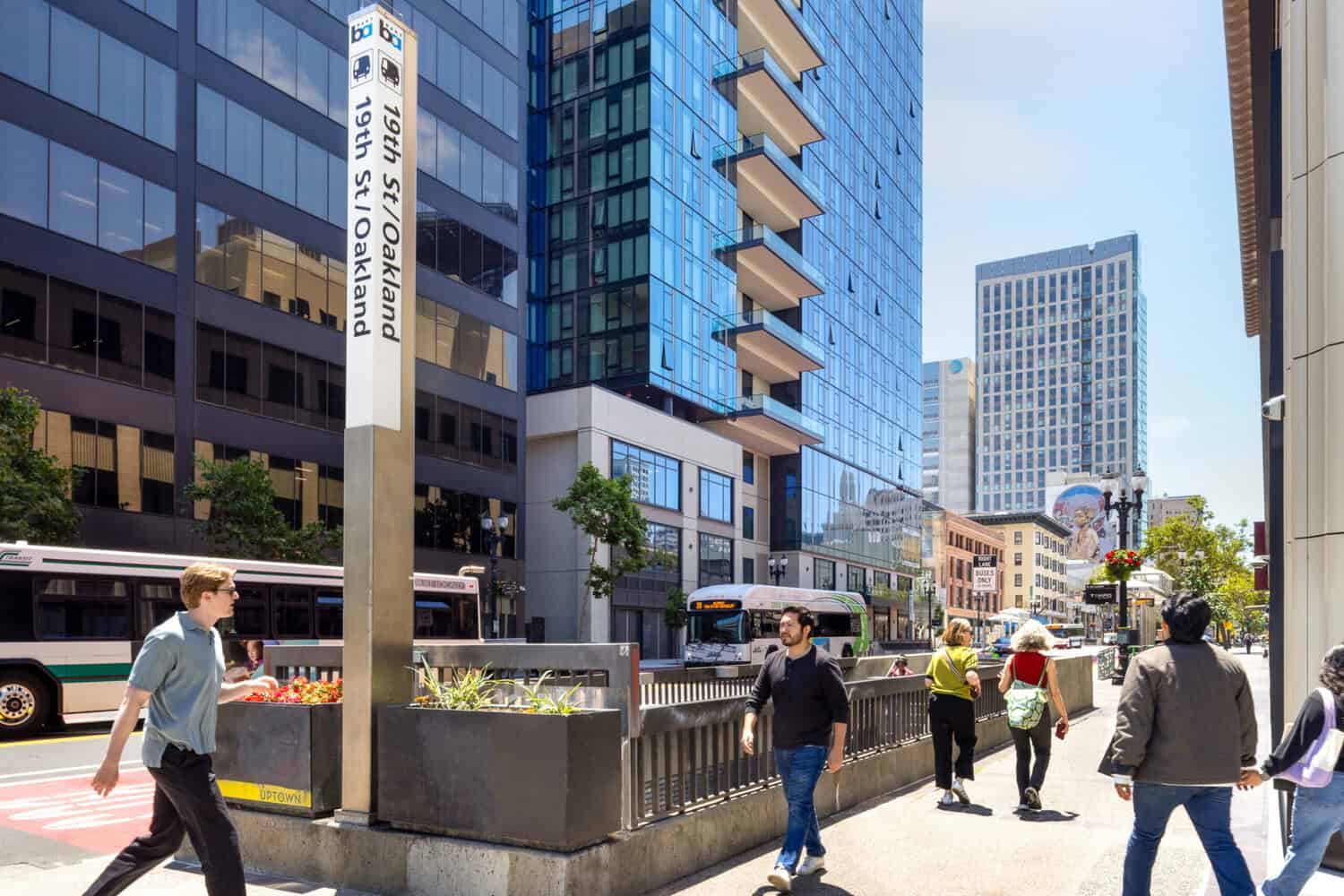Commuters walking at 19th Street and Broadway near the 19th Street BART entrance