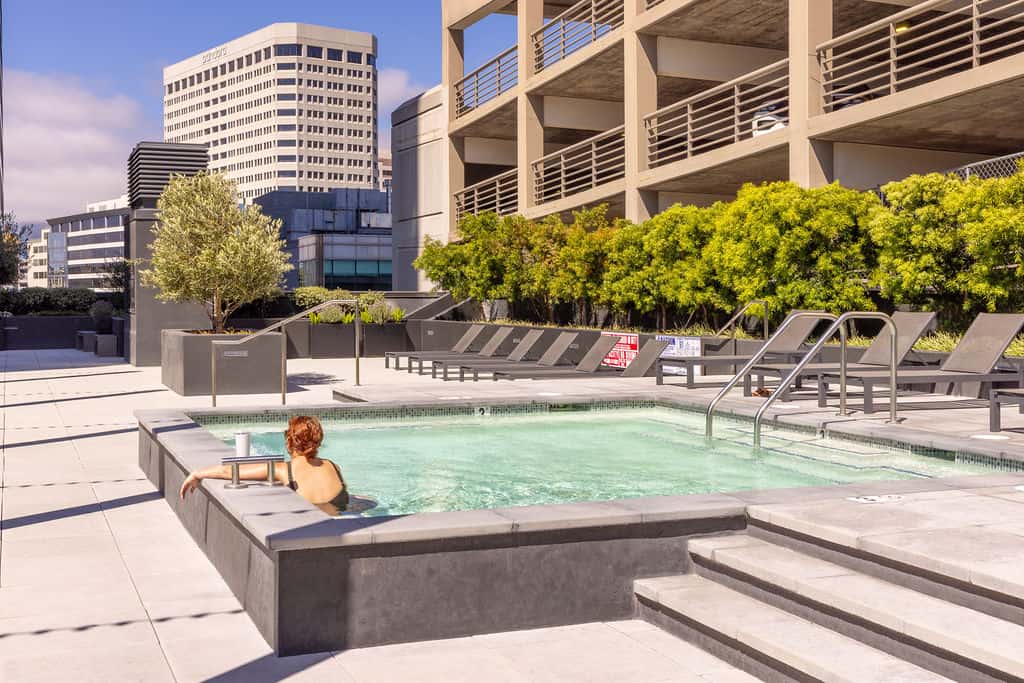 Pool deck with lounge chairs at 1900 Broadway in Oakland