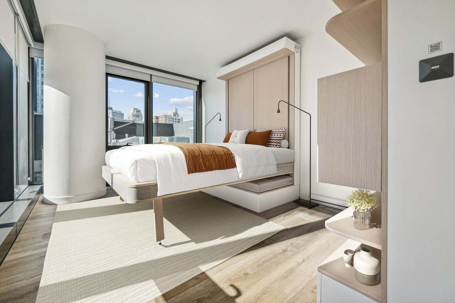 Furnished co-living bedroom with an Ori bed and city views at 1900 Broadway