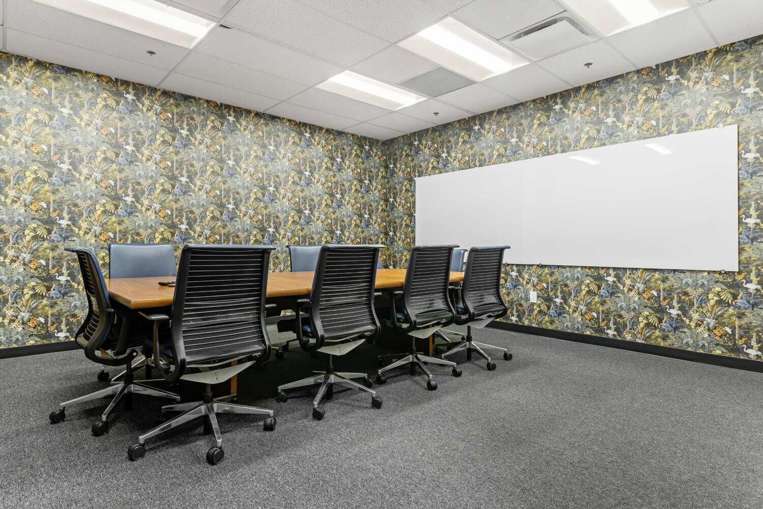 Birds of a Feather conference room with bird wallpaper and whiteboard at STAK Space 1950 Franklin, Oakland