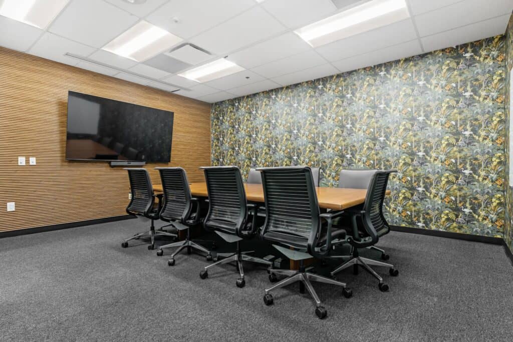 Birds of a Feather boardroom with a wall-mounted TV, a boardroom rental in Oakland at STAK Space