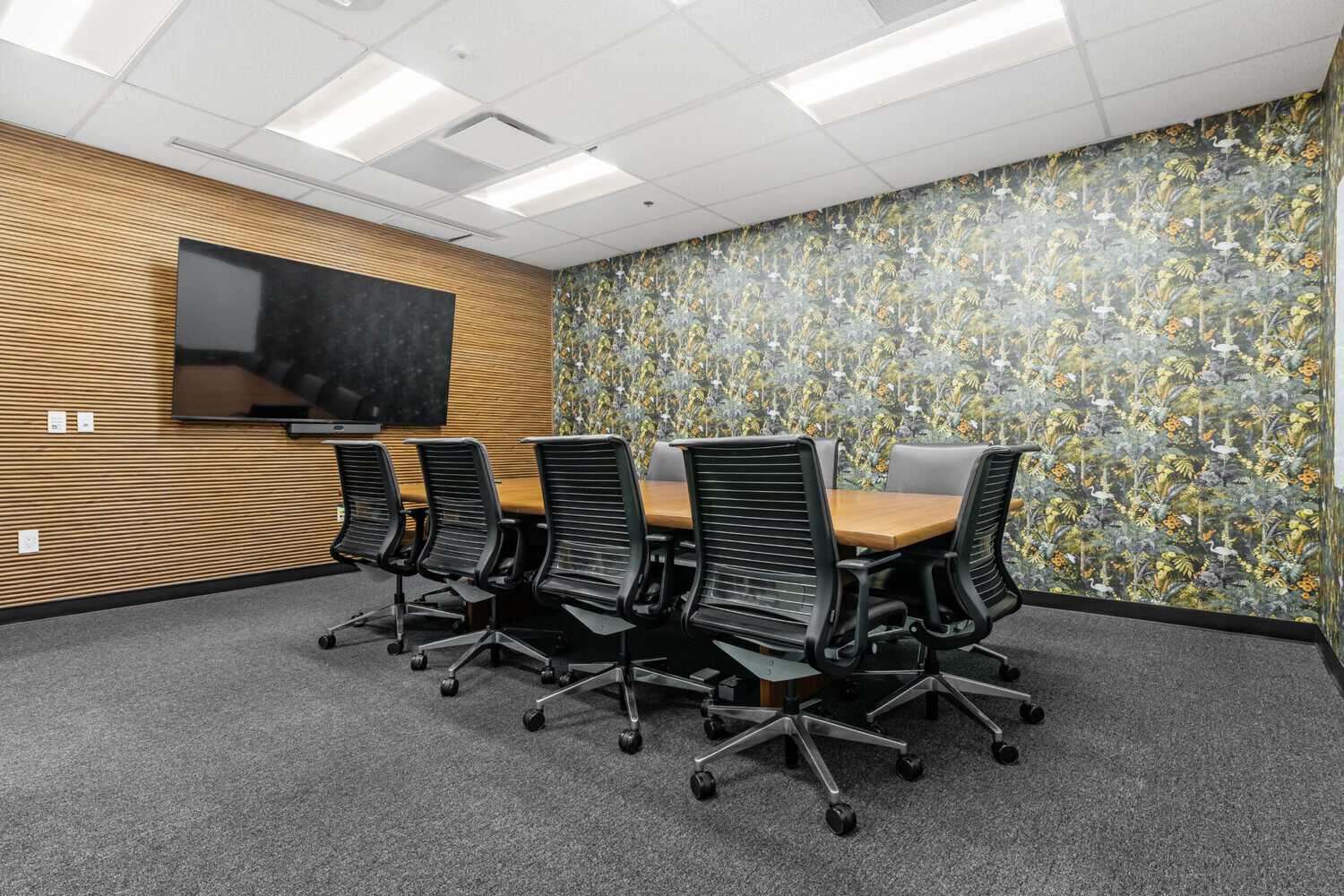 Birds of a Feather boardroom with wall-mounted TV at STAK Space 1950 Franklin, 17th floor