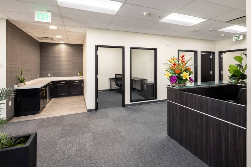 Kitchenette and private offices beside the reception in a Level 4 suite at 1950 Franklin