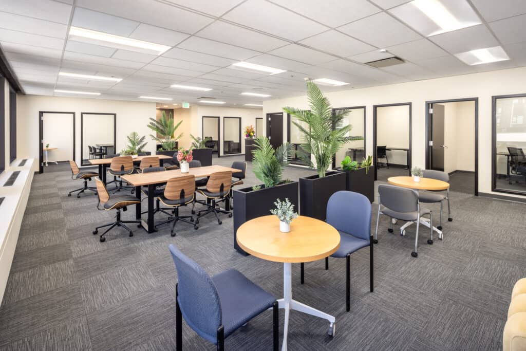 Cafe-style seating and open workspace in a Level 4 office suite at 1950 Franklin