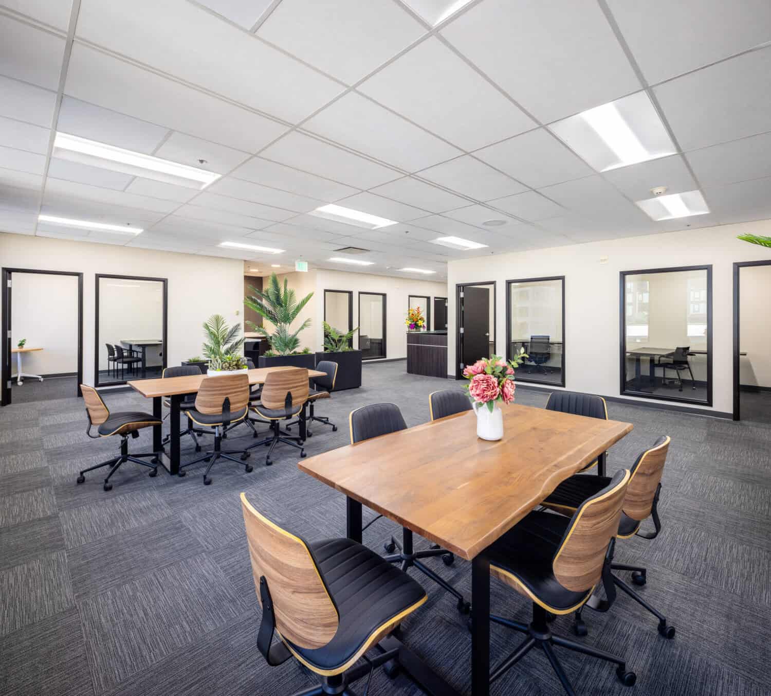 Team table and glass-front private offices in renovated office suites in Oakland on Level 4 at 1950 Franklin