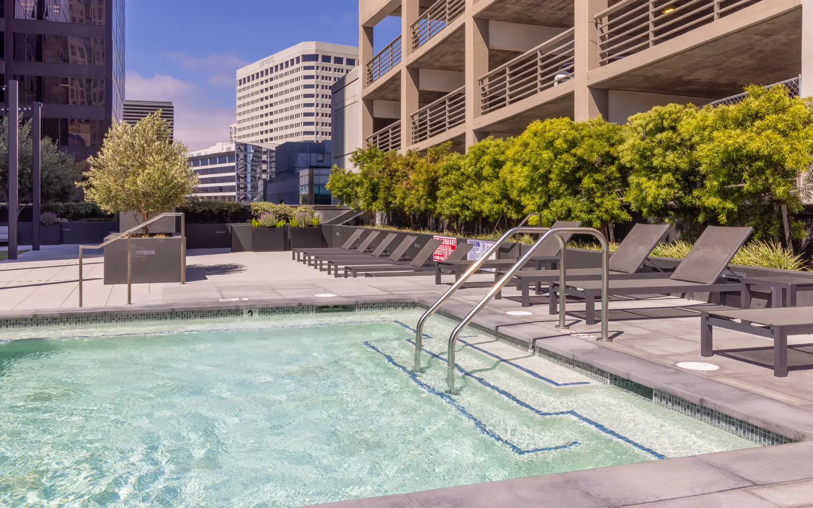 Pool deck with lounge chairs at 1900 Broadway on the STAK campus