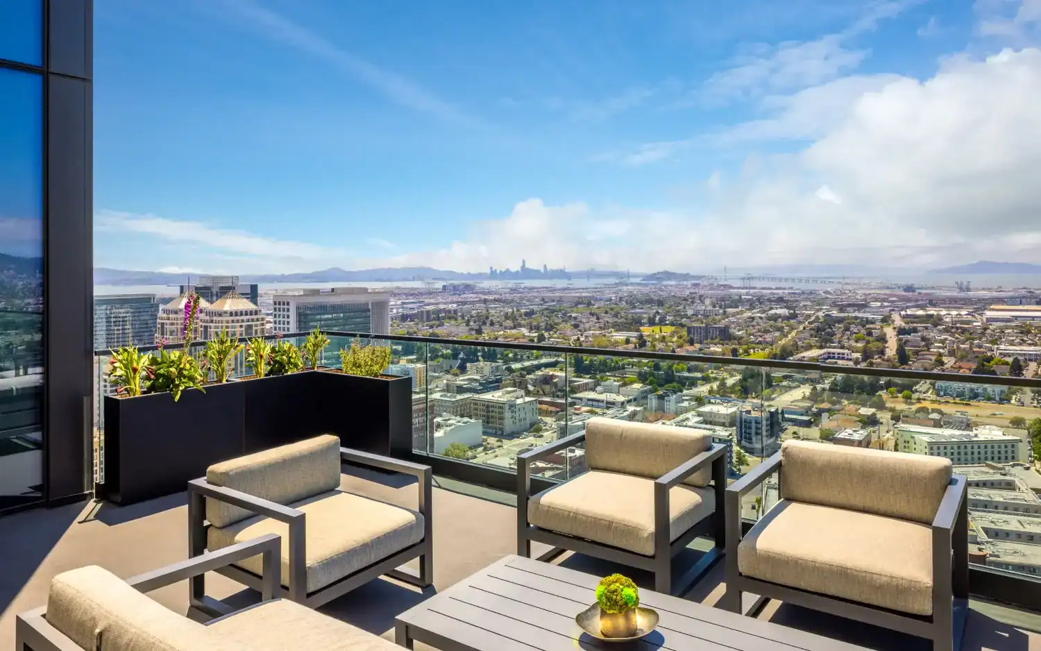 Rooftop lounge seating with views over Oakland and the Bay at the STAK campus