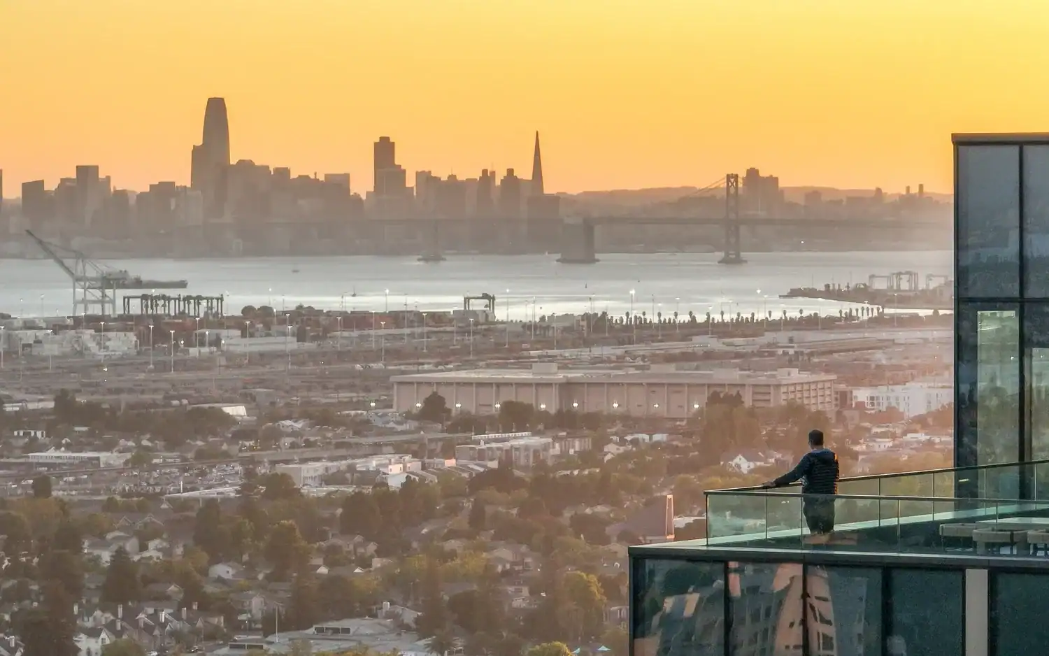 Sunset over the San Francisco skyline and Bay Bridge from the 1900 Broadway rooftop deck